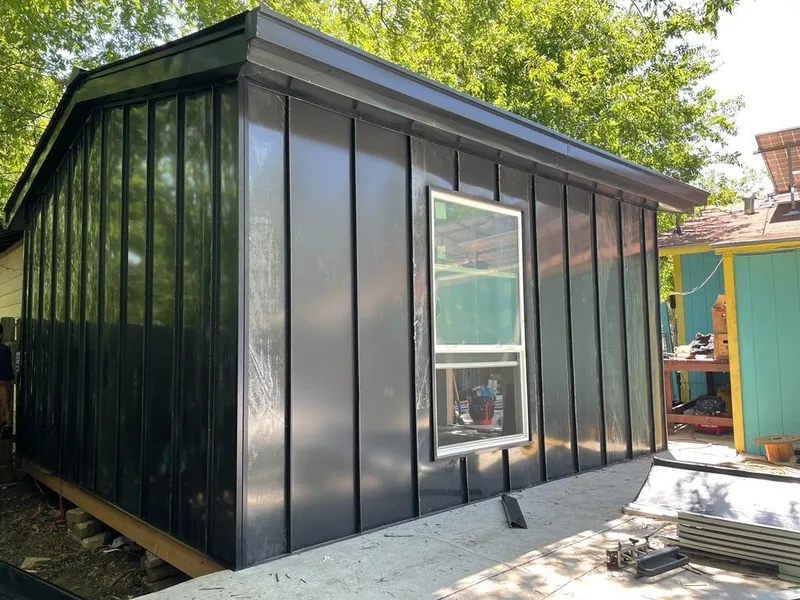 Black standing seam metal wall panels for Roof Inspection in The Meadows